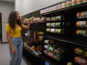 A student grabs an item from the shelves of the Kiah Duggins Shocker Support Locker