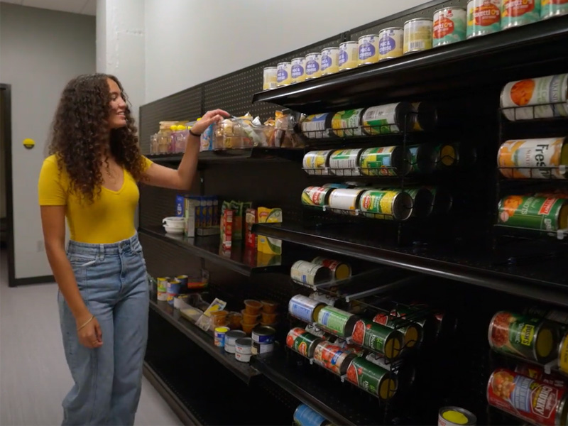 A student grabs an item from the shelves of the Kiah Duggins Shocker Support Locker