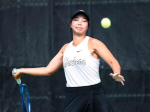 Xin Tong Wang prepares to return a serve at a tennis match