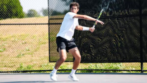 Zaid Al Mashni winds up to hit a serve