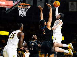 A member of the Shocker men's basketball team prepares to dunk the ball at a game in Charles Koch Arena