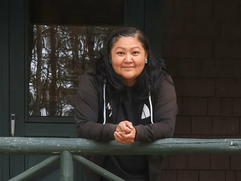 A smiling woman, artist Anna Tsouhlarakis