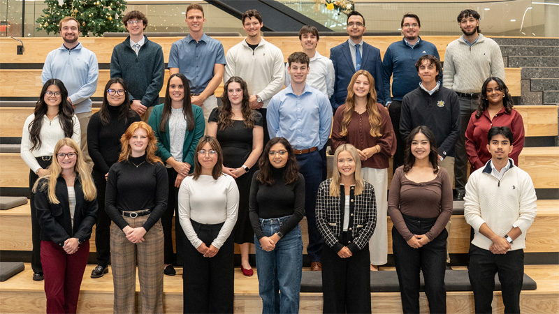 Barton School of Business's 2025 Class of 25 Under 25 posed on the social stairs in Woolsey Hall.
