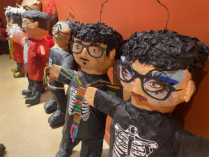 A row of piñatas created to look like artist Justin Favela