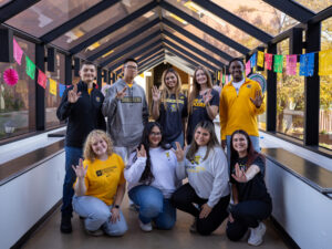 Students pose with the WSU Shocker hand sign