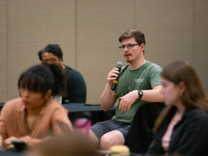 A student speaks asks a question to a guest speaker on Wichita State's campus
