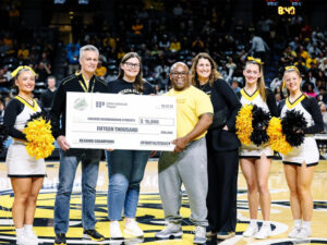President Rick Muma, Shocker cheer members and members of United Way present the money raised for the United Way Champions for Literacy 2025 campaign