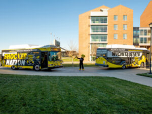 WuShock points to one of two Shocker shuttle buses on campus
