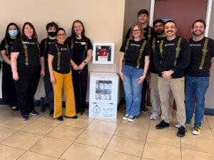 Hope Services team members gathered for the installation of the new naloxone distribution box at the Rhatigan Student Center