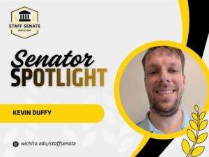 Staff Senate Wichita State Logo on top left corner. Senator Spotlight in bolded text in the middle, with Kevin Duffy written underneath it. A link to wichita.edu/staffsenate at the bottom left corner. Photo of the senator in the middle right of the page with black and yellow graphic wheat designs.