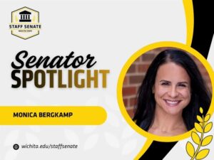 Staff Senate Wichita State Logo on top left corner. Senator Spotlight in bolded text in the middle, with Monica Bergkamp written underneath it. A link to wichita.edu/staffsenate at the bottom left corner. Photo of the senator in the middle right of the page with black and yellow graphic wheat designs.