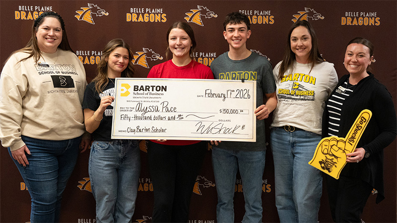Alyssa Pace holds up her Clay Barton Scholarship check with members of the Barton School of Business