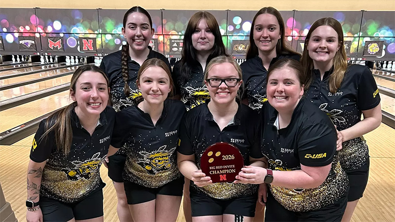 The Shocker women's bowling team holds up the winning Big Red Invite trophy