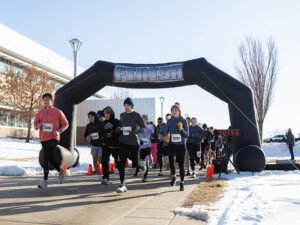 Participants at the start line of a snowy 5K