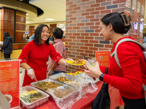 A student grabs food at a Lunar New Year event in the Rhatigan Student Center