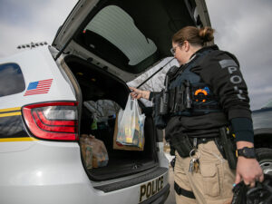 An officer with the University Police Departments loads up a squad car full of donations to deliver to the Kiah Duggins Shocker Support Locker