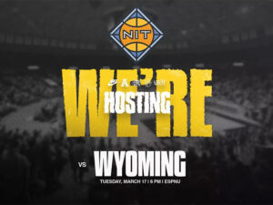 The NIT logo, a stylized basketball and blue diamond with the letters "NIT" at the front, various Shocker related logos, including the AAC logo and Nike logo, and the text "We're hosting. VS Wyoming Tuesday, March 17 | 6 PM | ESPN U" sit over a gray photo of Charles Koch Arena