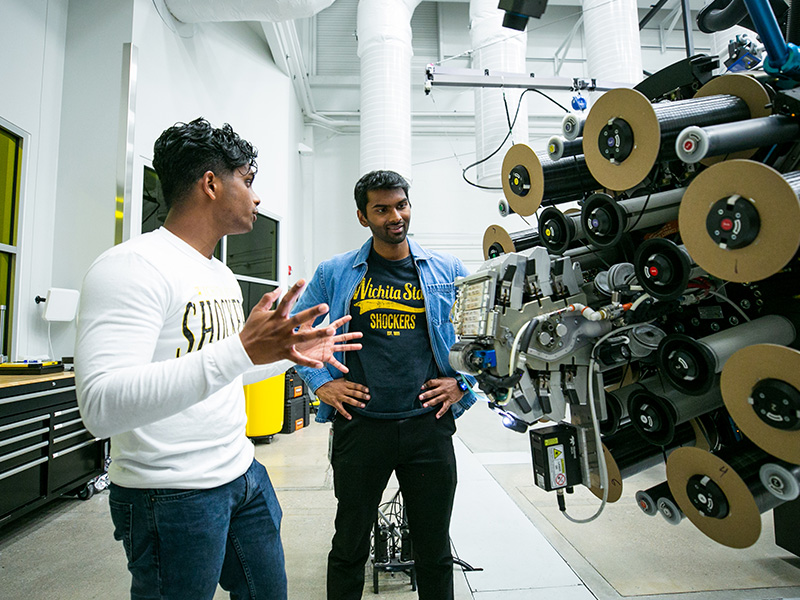 Students work on engineering equipment in a lab