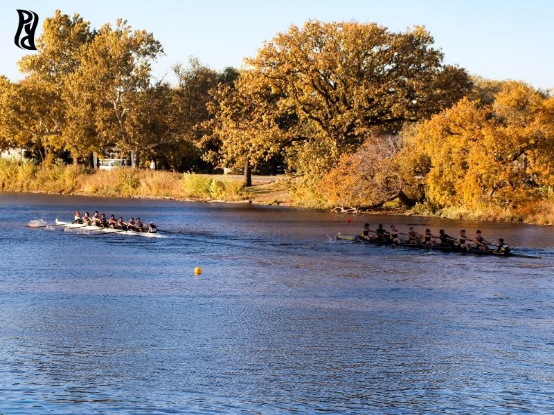 Students row in the Arkansas River during the fall.