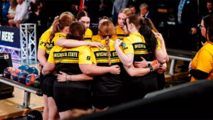 The Shocker women's bowling team huddle at the NCAA championships