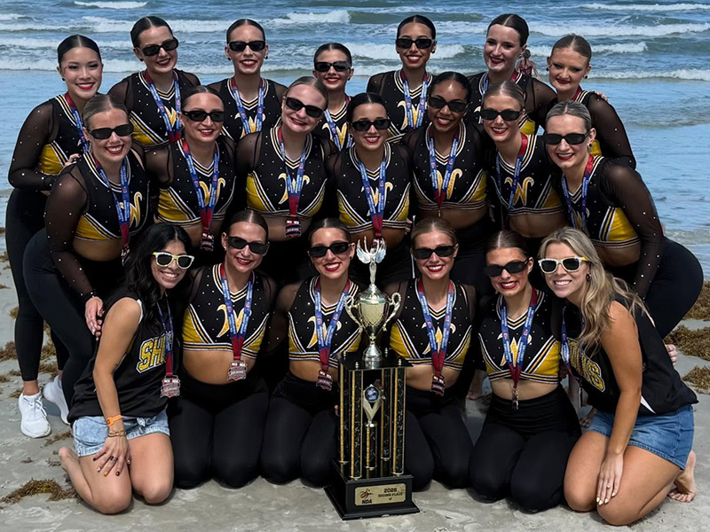 The Shocker dance team pose with the NDA trophy on the beach