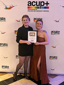 Bethany Hearn and Leah Lipke with gold award at the ACUP awards banquet.