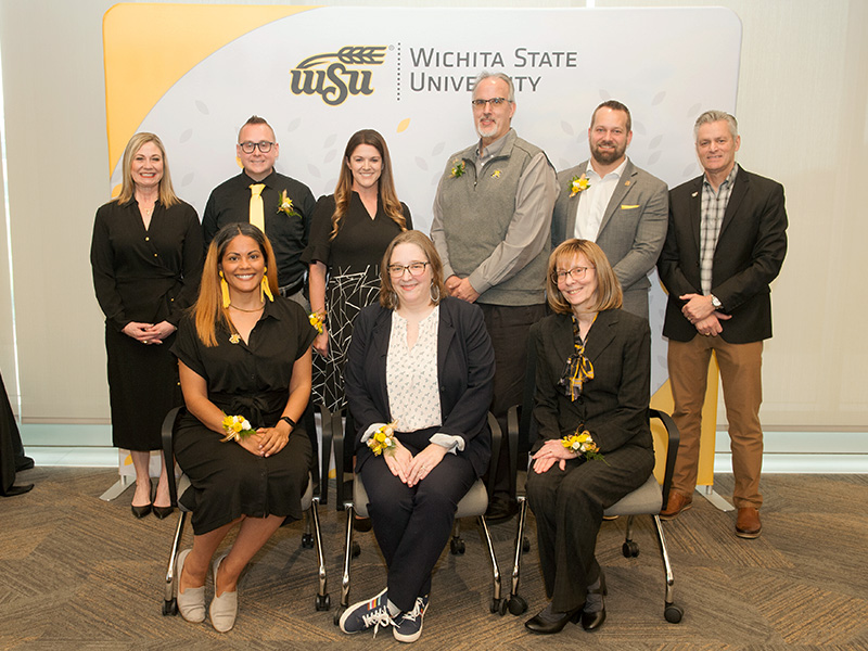 Faculty and staff who were recognized at the Shocker Pride Celebration pose with President Rick Muma and Provost Monica Lounsbery