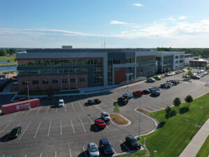 Aerial photo of the new ATF building on campus, with a parking lot in the foreground and cars parked