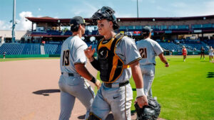 Members of the Shocker baseball team congratulate each other after successfully beating FAU