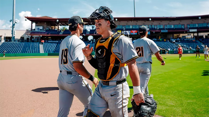 Members of the Shocker baseball team congratulate each other after successfully beating FAU