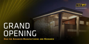 Image of the NIAR Hub for Advanced Manufacturing and Research building at night with the NIAR logo and text that reads 'GRAND OPENING Hub for Advanced Manufacturing and Research'