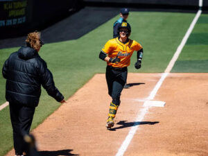 Kinzey Woody runs to home plate after a home run