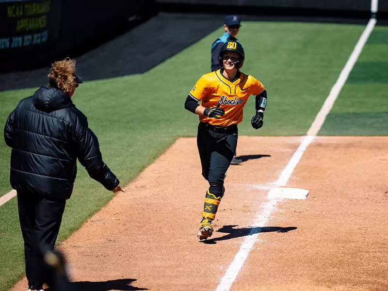 Kinzey Woody runs to home plate after a home run