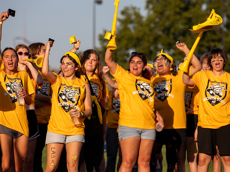 Students cheer on participants during Clash of the Colleges