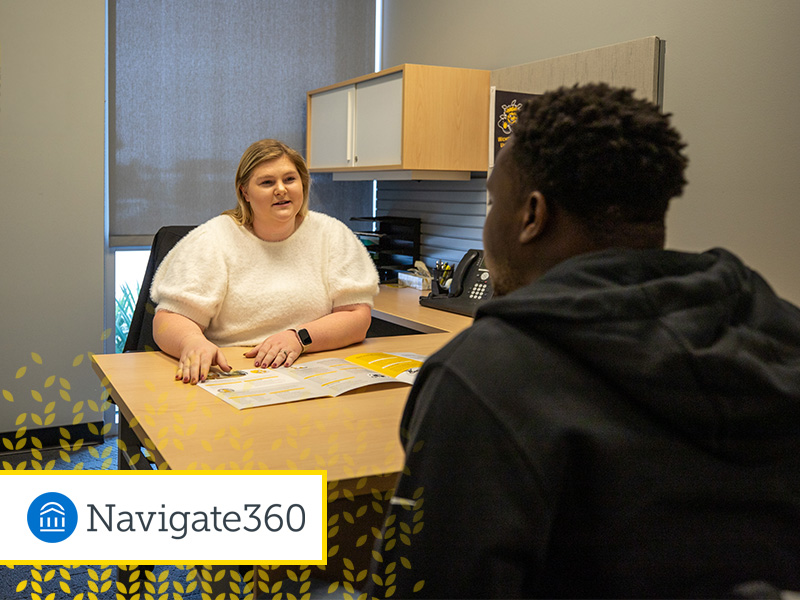 A student speaks to a staff member for assistance. In the bottom left corner is a white box with a yellow border with the Navigate360 logo in it. Behind the box is stylized yellow wheat kernels that start to fade from the corner.